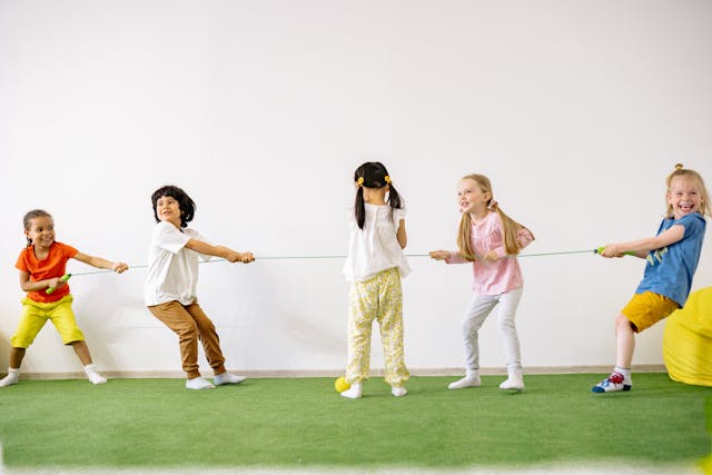 Group of children playing tug of war